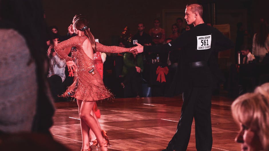 A couple performs a graceful ballroom dance routine on stage