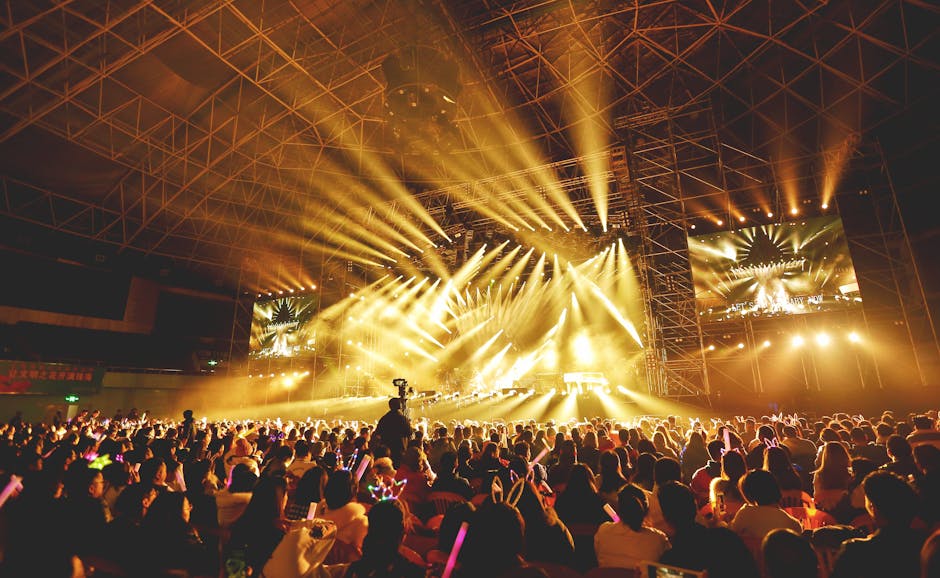 Dynamic concert scene with vibrant crowd and dazzling stage lights indoors