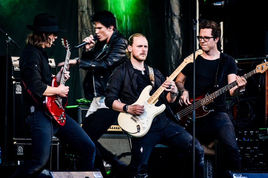 Rock band performing live with guitars and microphone on stage